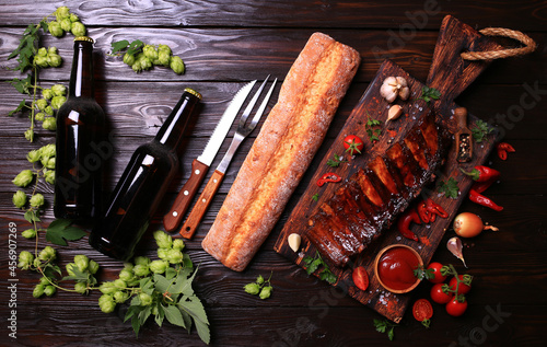 Fototapeta Naklejka Na Ścianę i Meble -  Grilled pork ribs with beer spices and vegetables on wooden background