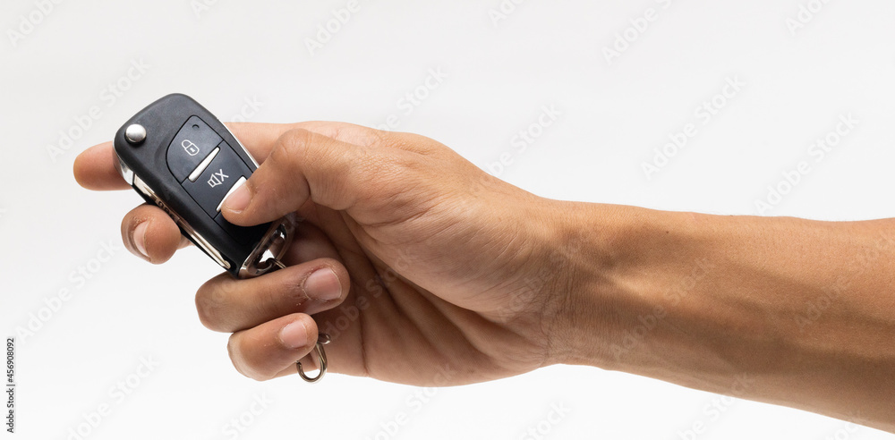 hand holding car remote isolated on white background 