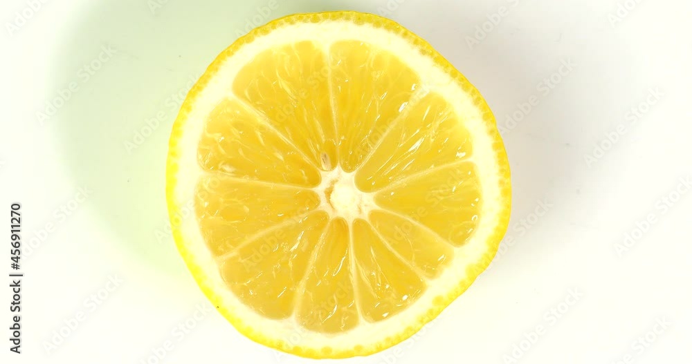 a slice of lemon is spinning on a plate