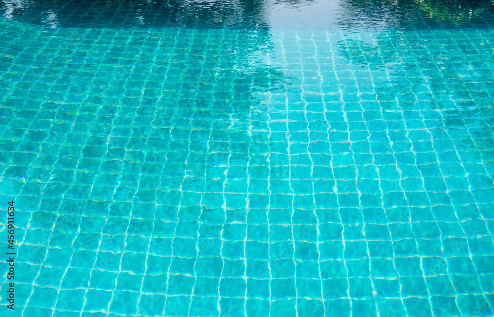 Part of swimming pool and with blue water.