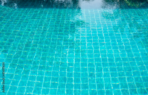 Part of swimming pool and with blue water.