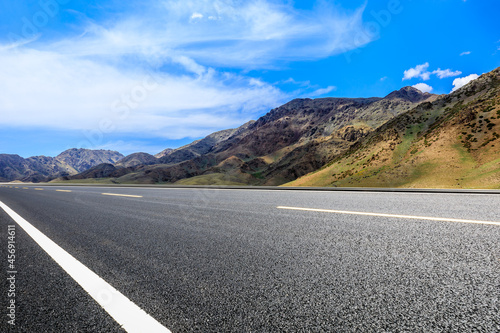 Highway ground and mountain natural scenery under blue sky.Landscape and highway.Outdoor road background.
