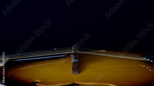 Mandolin, close camera movement on black background. Selective focus.