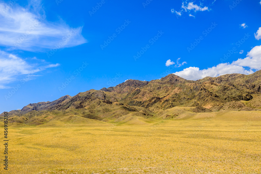 Xinjiang grassland and mountain scenery in autumn season,China.