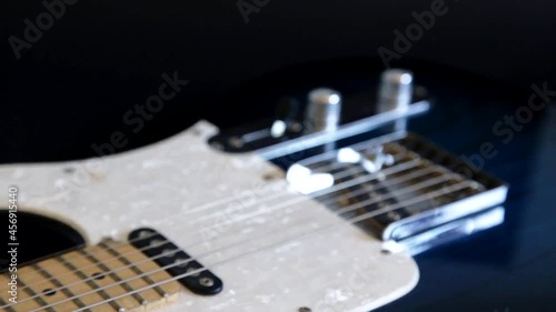 Closeup of an electric guitar. First blurry, then focused