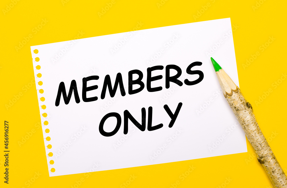 On a bright yellow background, a large wooden pencil and a white sheet of paper with the text MEMBERS ONLY On a bright yellow background, a large wooden pencil and a white sheet of paper with the text MEMBERS ONLY
