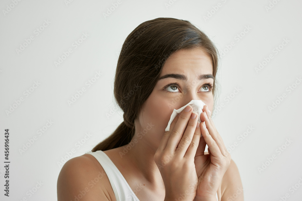 woman wiping her nose with a handkerchief cold health problems disorder woman wiping her nose with a handkerchief cold health problems disorder