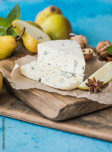 Gorgonzola picant Italian blue cheese, made from unskimmed cow's milk in North of Italy. Piece of blue mould cheese danablu,  roquefort with pear and walnuts photo