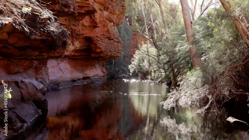 the sun shining on a pool of water at the garden eden in kings canyon in watarrka national park of the northern territory, australia