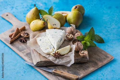 Gorgonzola picant Italian blue cheese, made from unskimmed cow's milk in North of Italy. Piece of blue mould cheese danablu,  roquefort with pear and walnuts photo