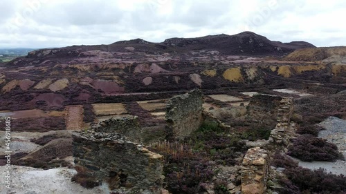 Parys mountain rocky copper mining stone ruin excavation quarry aerial rising view Anglesey mine Wales UK photo