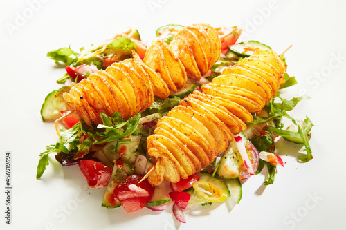 Twist potatoes and vegetable salad on white background
