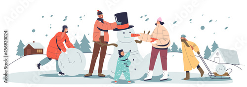 Happy family on winter holidays outdoors making snowman together. Parents with three kids playing