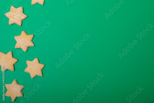 Composition of christmas cookies and copy space on green background