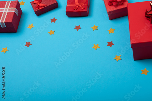 Composition of presents with stars and copy space on blue background