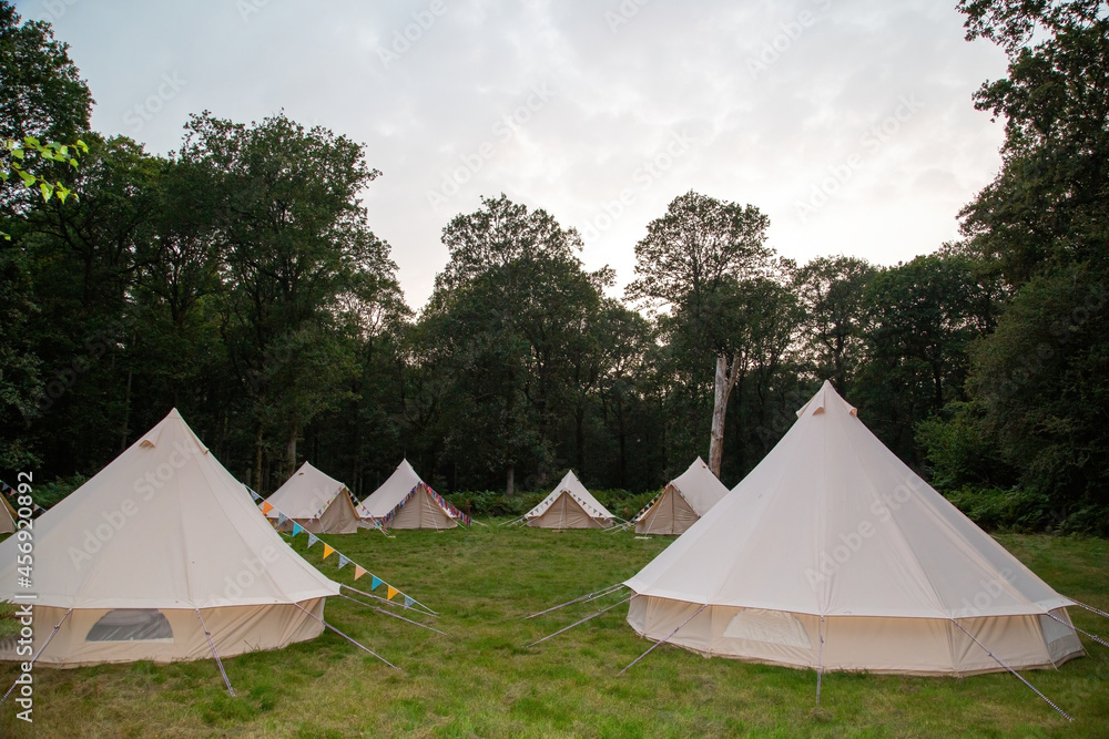 Glamping teepees in a circle in a field
