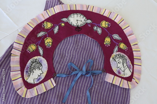 Bild auf Leinwand Embroidered collar with roses on chair