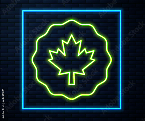 Glowing neon line Canadian maple leaf icon isolated on brick wall background. Canada symbol maple leaf. Vector