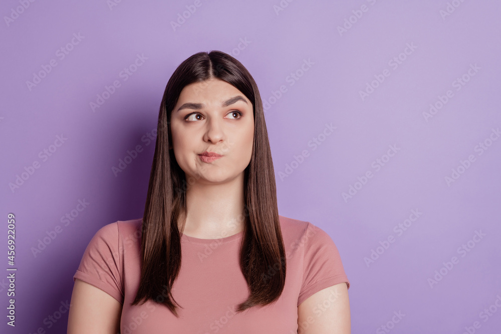 Portrait of young beautiful thoughtful cute girl look copyspace unsure hesitate isolated on violet color background Portrait of young beautiful thoughtful cute girl look copyspace unsure hesitate isolated on violet color background