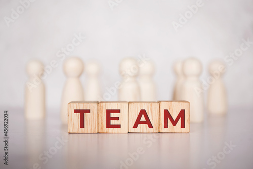 Word team on wooden block, relationship of collaboration and leadership for success, group of community and employee with corporate, teamwork for brainstorming together, no people, business concepts.