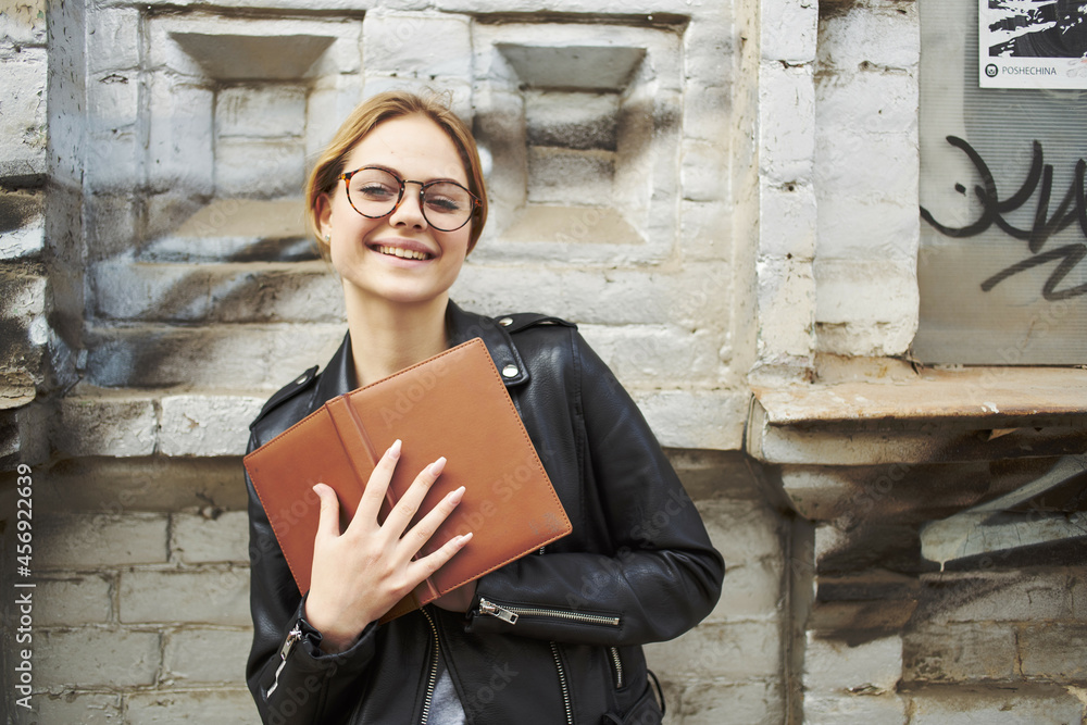 pretty woman in leather jacket posing studio walking outdoors