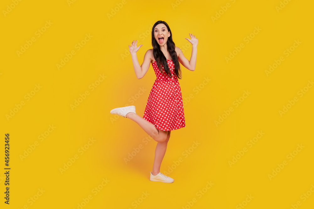 Portrait of funky excited astonished lady scream rejoice wear dotted red mini dress sneakers on yellow background Portrait of funky excited astonished lady scream rejoice wear dotted red mini dress sneakers on yellow background