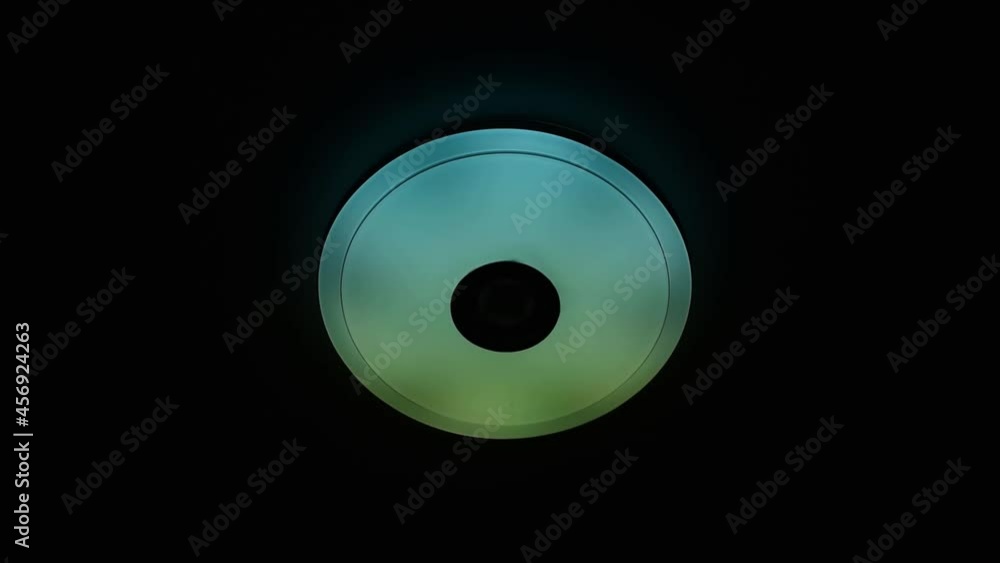 Multi colored LED flashing ceiling lighting with built-in wireless speaker over black background. Multi colored LED flashing ceiling lighting with built-in wireless speaker over black background.