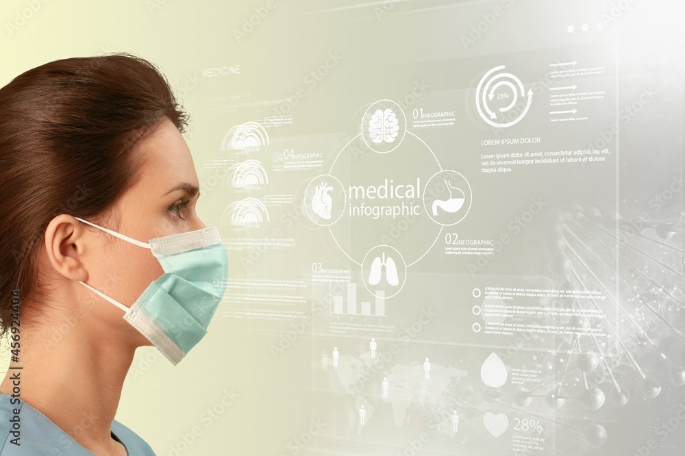female scientist with face mask looking at data on a transparent digital screen female scientist with face mask looking at data on a transparent digital screen