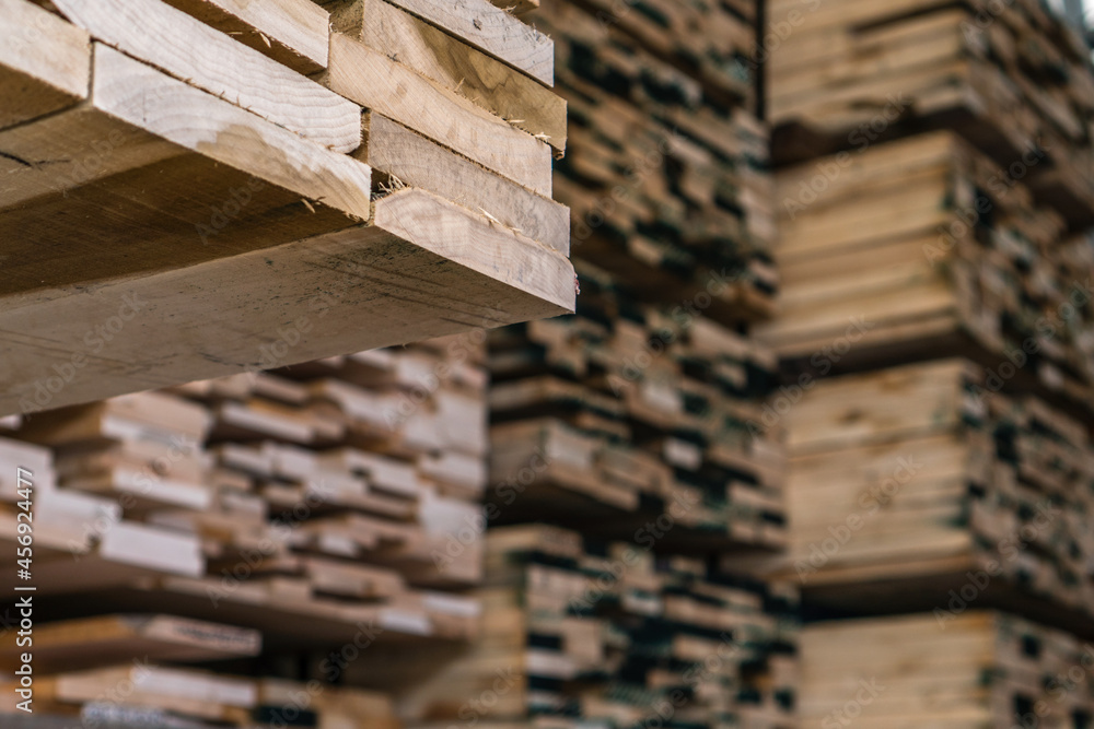 Stacks of lumber on a rack for sale to consumers at a retail hardwood lumber business Stacks of lumber on a rack for sale to consumers at a retail hardwood lumber business