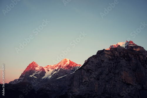 Mountain sunset panorama in Switzerland. Summer landscape with the sun at dawn.