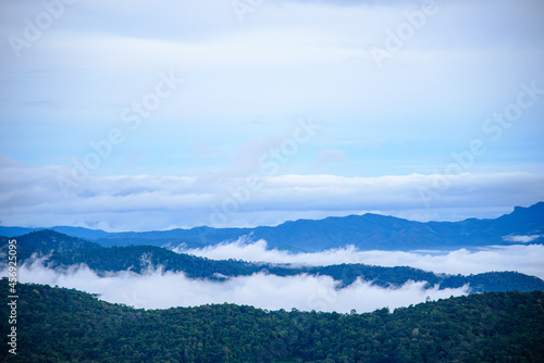 A Morning landscape with thick fog, sky and misty mountains, beautiful.