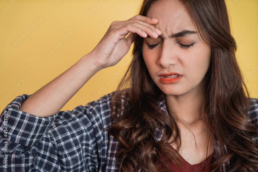 close up of an asian woman holding head with hands when dizzy close up of an asian woman holding head with hands when dizzy