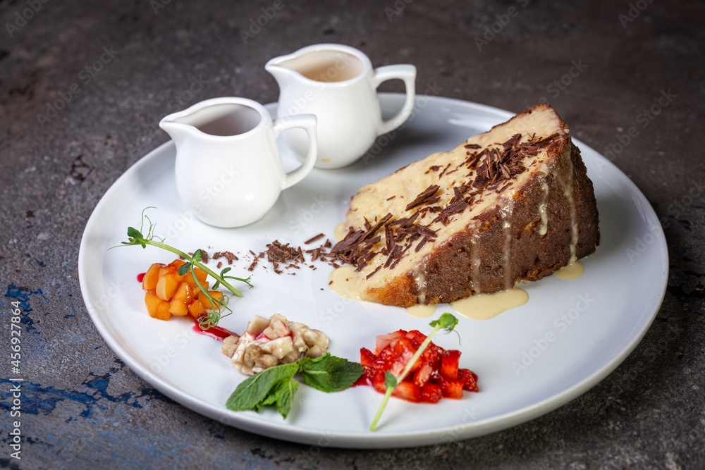 honey cake with chocolate chips and berries in a cafe on a white plate honey cake with chocolate chips and berries in a cafe on a white plate