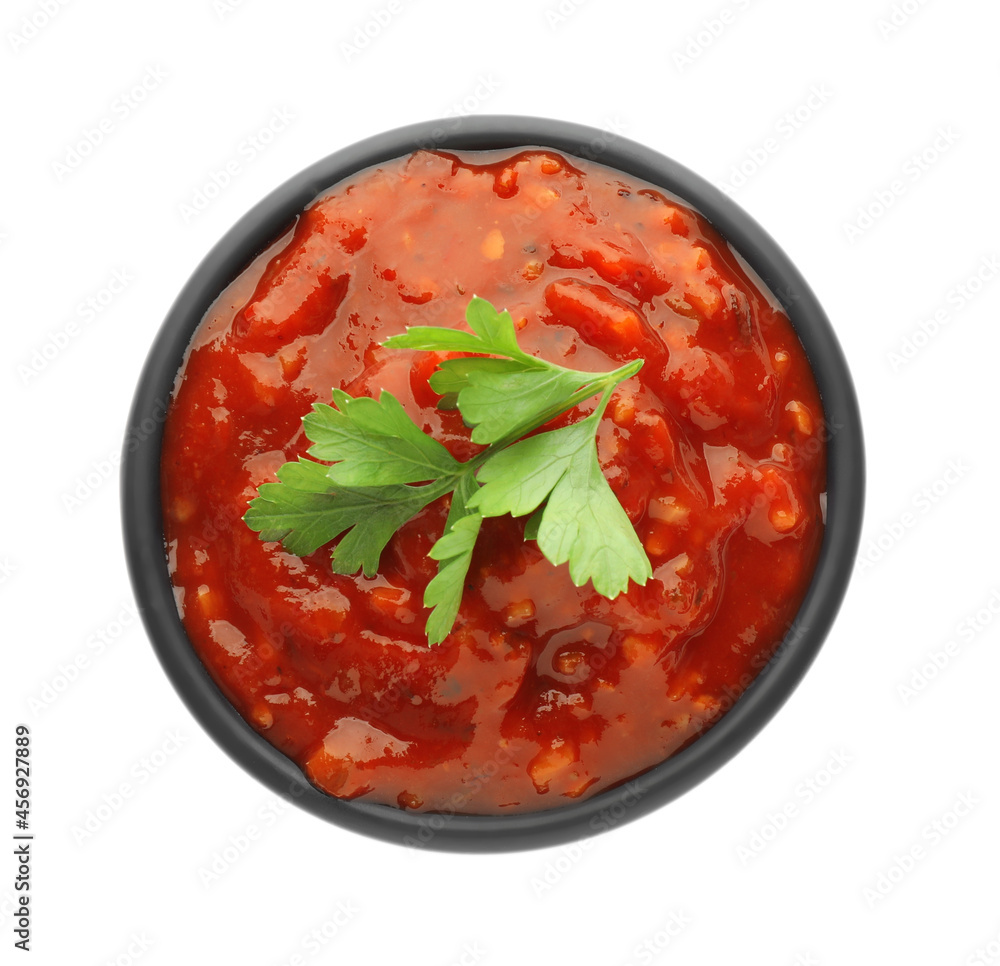 Delicious adjika sauce and parsley in bowl isolated on white, top view Delicious adjika sauce and parsley in bowl isolated on white, top view