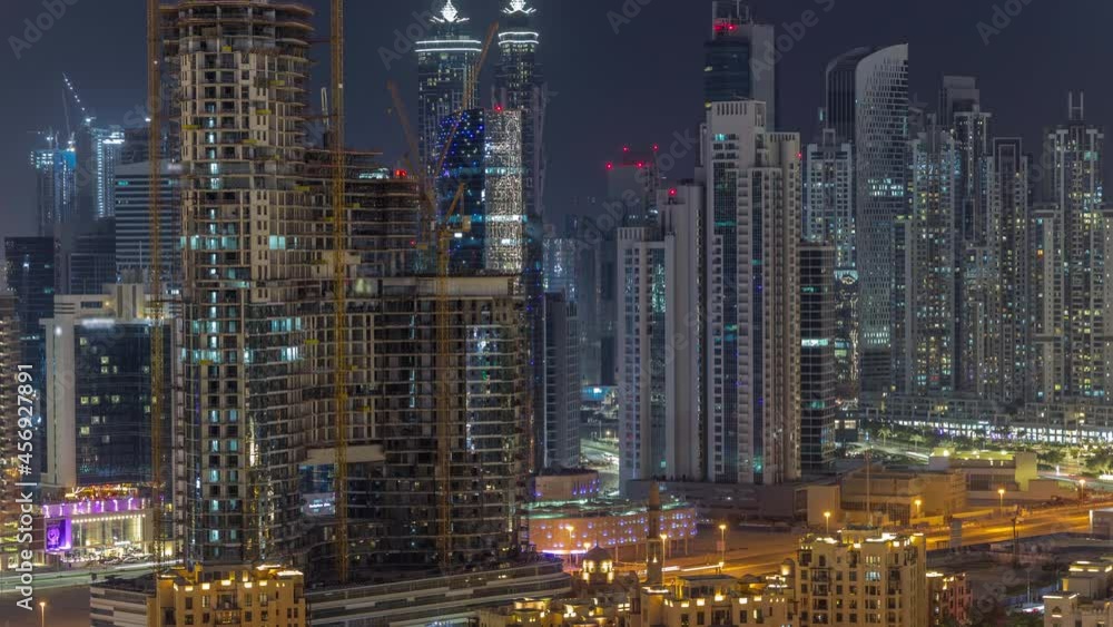 Dubai's business bay towers aerial night timelapse. Rooftop view of some skyscrapers Dubai's business bay towers aerial night timelapse. Rooftop view of some skyscrapers