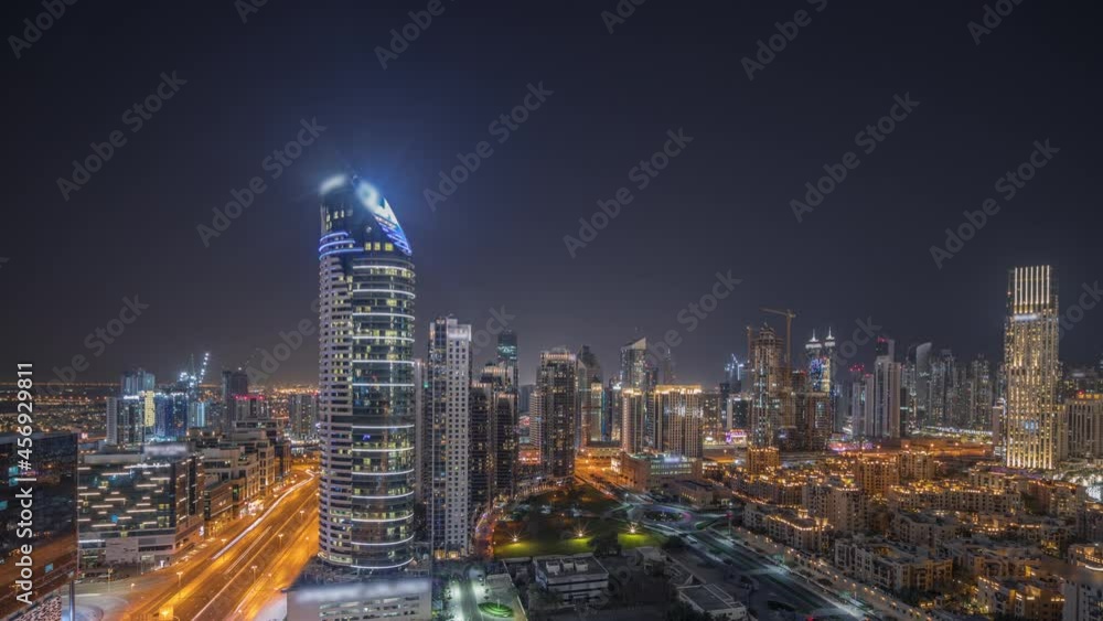 Panorama showing Dubai's business bay towers aerial night timelapse. Rooftop view of some skyscrapers Panorama showing Dubai's business bay towers aerial night timelapse. Rooftop view of some skyscrapers