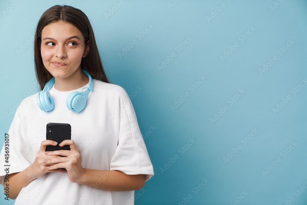 Young white woman looking aside while using mobile phone Young white woman looking aside while using mobile phone