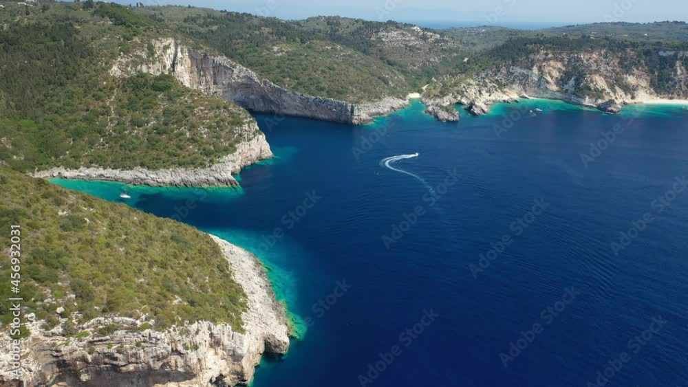 Aerial drone video of sail boats and yachts cruising in tropical exotic island paradise bay with white rock caves and deep blue clear sea Aerial drone video of sail boats and yachts cruising in tropical exotic island paradise bay with white rock caves and deep blue clear sea