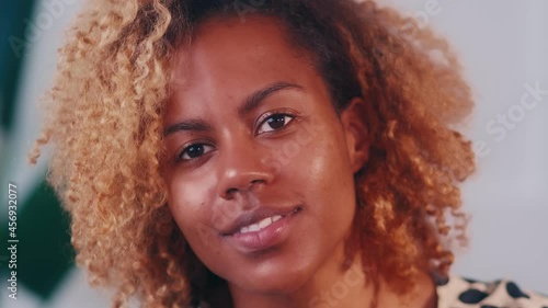 Wallpaper Mural Close up portrait of confident African American curly woman having cute smile. Face of beautiful young mixed race woman who coquettishly smiles looking at camera. Concept of human feelings. Torontodigital.ca