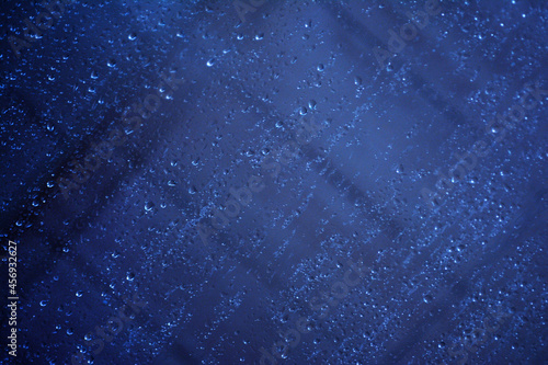Abstract image of fogged glass with drops running down it.