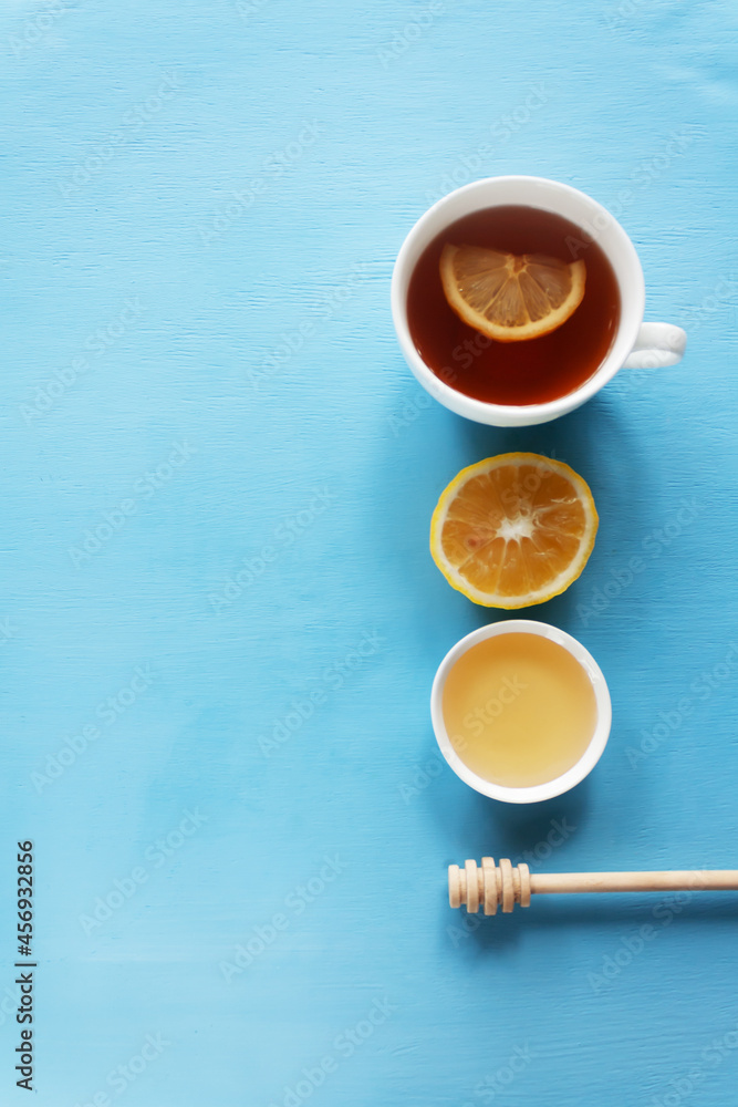 .tea with lemon and honey on a blue background. Hot healthy winter drink. Alternative medicine concept .tea with lemon and honey on a blue background. Hot healthy winter drink. Alternative medicine concept