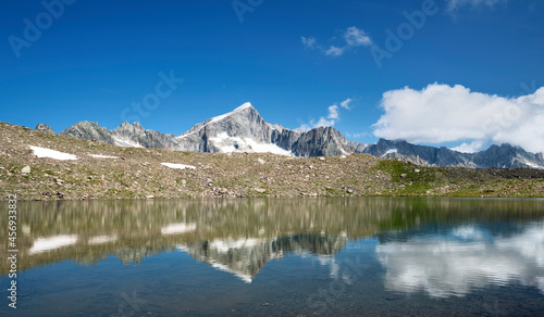 Rocky mountain reflecting in an mountain lake at a sunny day near Furka Pass. Uri Alps  Switzerland  Europe