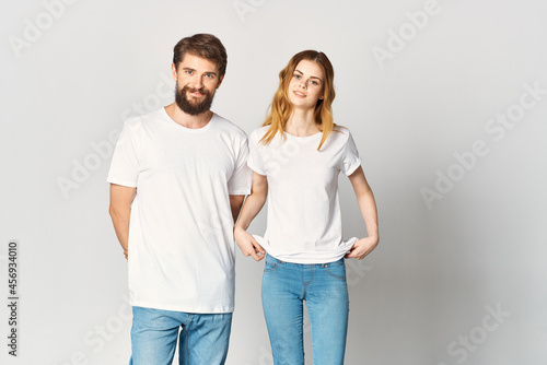 man and woman in white t-shirts and jeans design fashion copy space studio