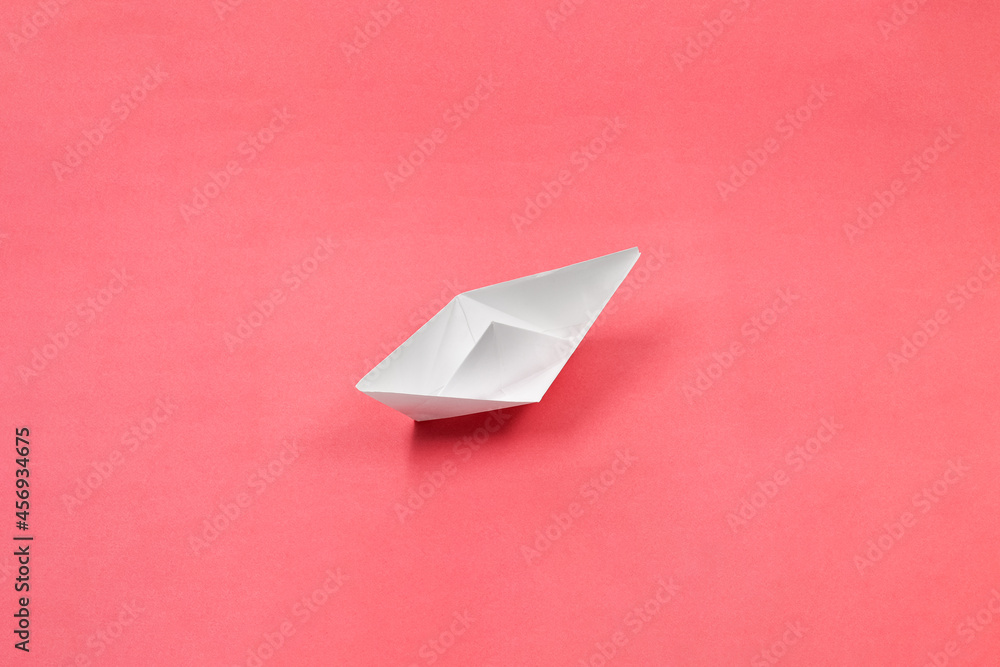Paper boat as a symbol of business standing at the beginning of business development Paper boat as a symbol of business standing at the beginning of business development