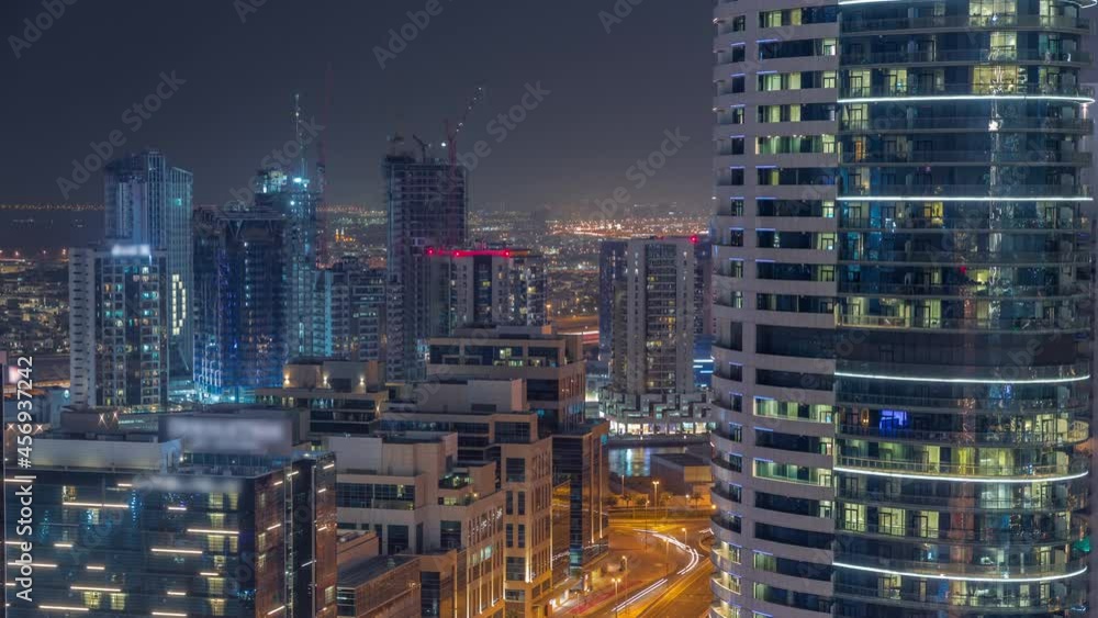 Dubai's business bay towers aerial night timelapse. Rooftop view of some skyscrapers Dubai's business bay towers aerial night timelapse. Rooftop view of some skyscrapers