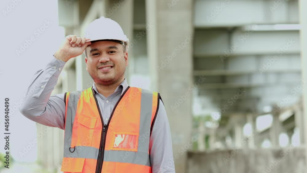 Asian engineer handsome man or architect looking construction with white safety helmet in construction site. Standing at highway concrete road site.
Asian engineer handsome man or architect looking construction with white safety helmet in construction site. Standing at highway concrete road site.