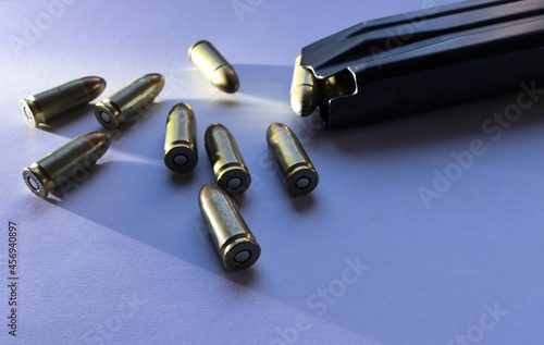 Slika na platnu 9mm caliber parabellum bullets isolated with grazing light next to a magazine of