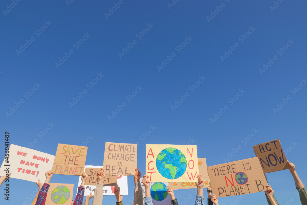 Group of people with posters protesting against climate change outdoors, closeup - obrazy, fototapety, plakaty 