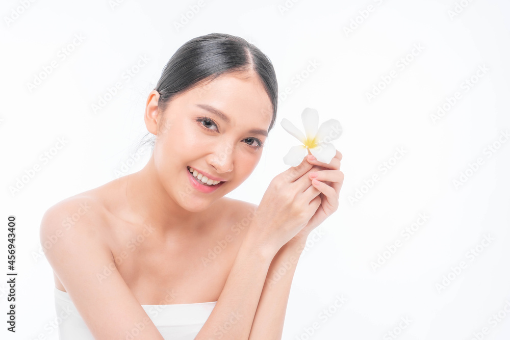 Beautiful young Asian woman with clean skin ,Fresh skin holding white flower tropical leaf in hands on white background - Beauty shot of Asian woman Facial treatment , Cosmetology , beauty and spa Beautiful young Asian woman with clean skin ,Fresh skin holding white flower tropical leaf in hands on white background - Beauty shot of Asian woman Facial treatment , Cosmetology , beauty and spa