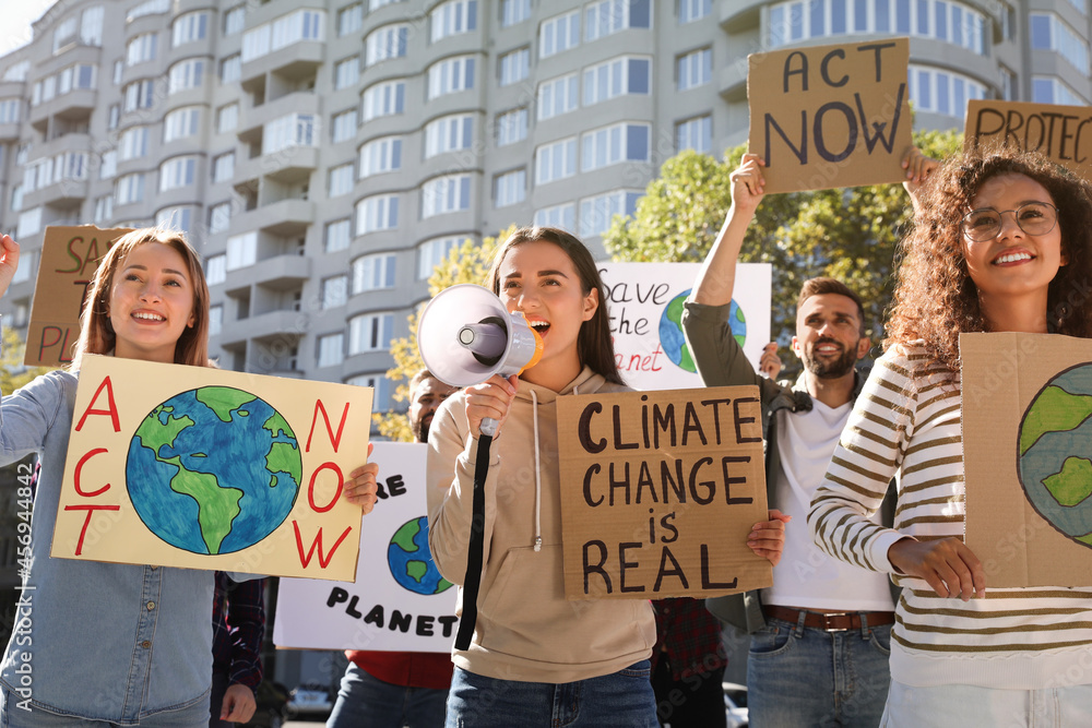 Group of people with posters protesting against climate change outdoors ...